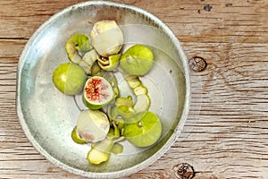 Halved, ripe figs in vintage/retro kitchen setting