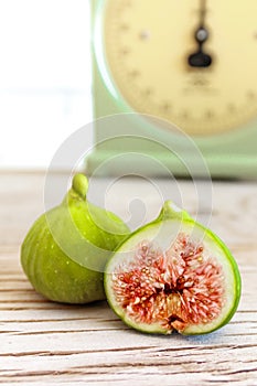 Halved, ripe figs in vintage/retro kitchen setting photo