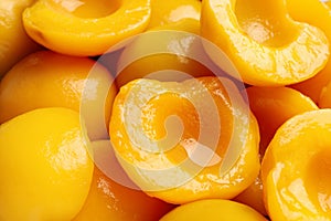 Halves of canned peaches as background, closeup