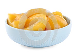 Halves of canned peaches in bowl isolated on white