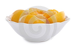 Halves of canned peaches in bowl isolated on white