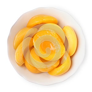 Halves of canned peaches in bowl isolated on white, top view