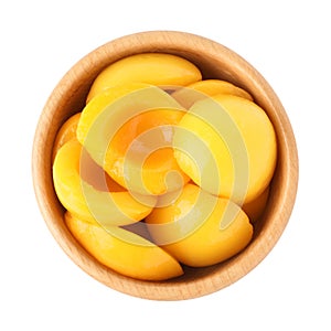 Halves of canned peaches in wooden bowl isolated on white, top view