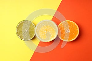 Halves of citrus fruits on two tone background