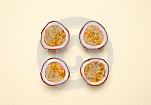 Halves of fresh ripe passion fruits maracuyas on background, flat lay