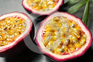 Halves of passion fruits maracuyas on table, closeup