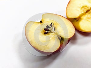 Halves of a red apple. Seeds began to germinate in the body of the apple. Close-up