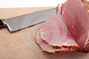 ham on a board with knife