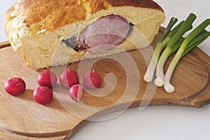 Ham in a bread on a cutting board