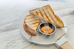 Ham cheese sandwich with custard sauce on marble