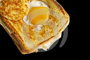 Ham and cheese sandwich with fried egg isolated on black background