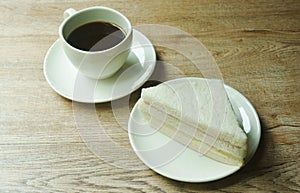 ham cheese sandwich on plate and black coffee cup