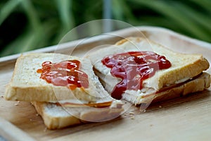 Ham cheese sandwich, tomato ketchup and chili sauce on wood tray and space for write wording