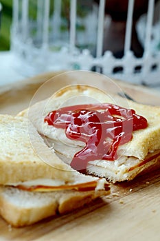 Ham cheese sandwich and tomato ketchup on wood tray and space for write wording,