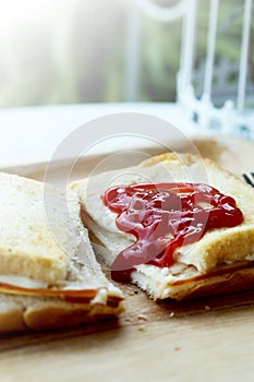 Ham cheese sandwich and tomato ketchup on wood tray and space for write wording,