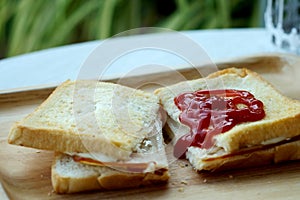 Ham cheese sandwich and tomato ketchup on wood tray and space for write wording,