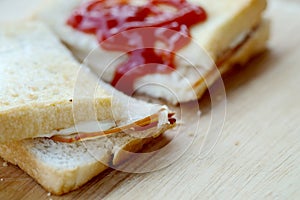 Ham cheese sandwich and tomato ketchup on wood tray and space for write wording,