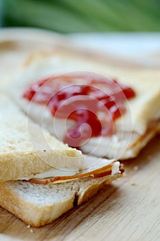 Ham cheese sandwich and tomato ketchup on wood tray and space for write wording,