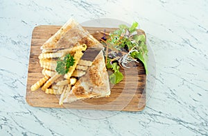 Ham Cheese sandwiches with french fries on wooden tray
