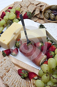 Ham, chips and crackers, olives, grapes, strawberries and cheese