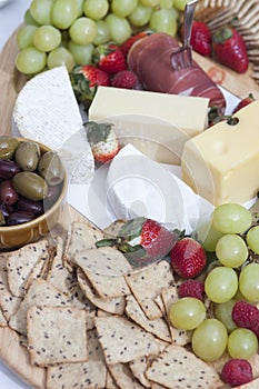 Ham, chips and crackers, olives, grapes, strawberries and cheese