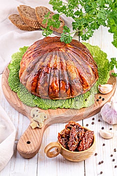 ham on a cutting board with herbs and spices