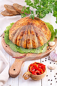 Ham on a cutting board with herbs and spices