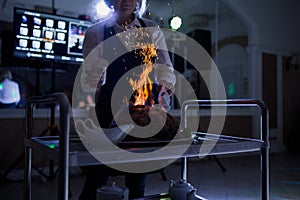 Ham flambe in a restaurant with a cook