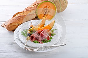 Ham with melon and olives