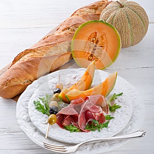 Ham with melon and olives