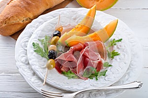 Ham with melon and olives
