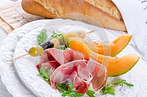 Ham with melon and olives