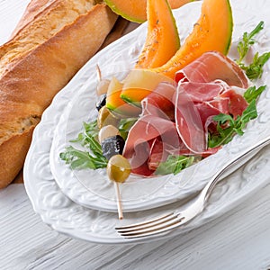 Ham with melon and olives