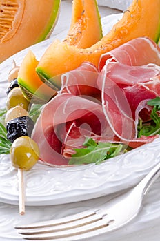 Ham with melon and olives