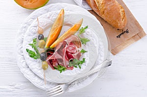 Ham with melon and olives