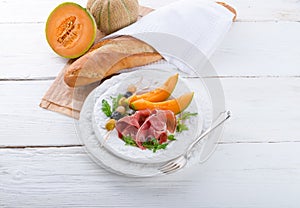 Ham with melon and olives