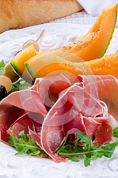 Ham with melon and olives