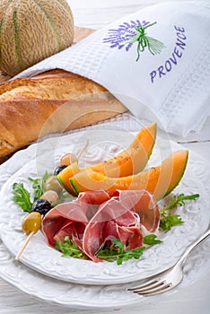 Ham with melon and olives