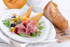 Ham with melon and olives