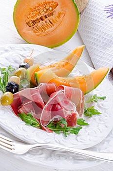 Ham with melon and olives