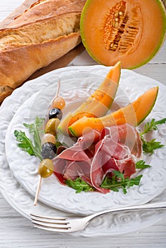 Ham with melon and olives