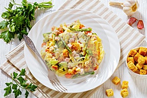 Ham and Noodle Casserole on white plate, top view