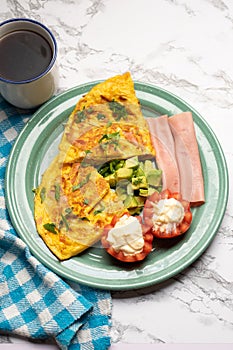 Ham omelette with avocado and tomato