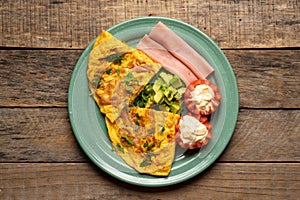 Ham omelette with avocado and tomato