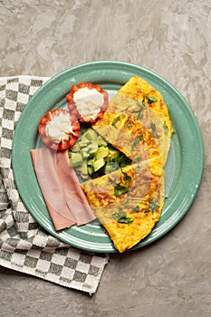 Ham omelette with avocado and tomato