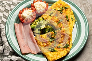 Ham omelette with avocado and tomato