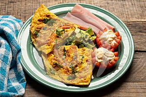 Ham omelette with avocado and tomato