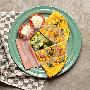 Ham omelette with avocado and tomato