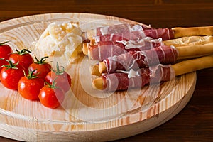 Ham rolled in breadsticks cheese and cherry tomatoes