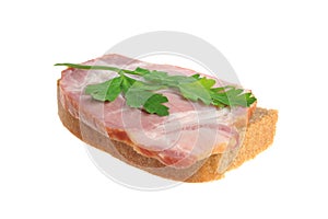 A ham sandwich with green leaf of parsley isolated on white